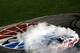 CHARLOTTE, NC - MAY 19: Jimmie Johnson, driver of the #48 Lowe's Patriotic Chevrolet, celebrates with a burnout after winning the NASCAR Sprint All-Star Race at Charlotte Motor Speedway on May 19, 2012 in Charlotte, North Carolina. (Photo by Streeter Lecka/Getty Images)