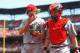 ST. LOUIS, MO - APRIL 19: Bronson Arroyo #61 and Ryan Hanigan #29 both of the Cincinnati Reds return to the dugout against the the St. Louis Cardinals at Busch Stadium on April 19, 2012 in St. Louis, Missouri. The Reds defeated the Cardinals 6-3. (Photo by Dilip Vishwanat/Getty Images)
