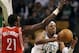 BOSTON, MA - MARCH 06: Paul Pierce #34 of the Boston Celtics passes under pressure from Samuel Dalembert #21 of the Houston Rockets on March 6, 2012 at TD Garden in Boston, Massachusetts. The Boston Celtics defeated the Houston Rockets 97-92 in overtime. NOTE TO USER: User expressly acknowledges and agrees that, by downloading and or using this photograph, User is consenting to the terms and conditions of the Getty Images License Agreement. (Photo by Elsa/Getty Images)