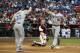 PHOENIX, AZ - MAY 21: Matt Treanor #18 (R) of the Los Angeles Dodgers high fives Jerry Sands #30 after hitting a two run home-run against the Arizona Diamondbacks during the second inning of the MLB game at Chase Field on May 21, 2012 in Phoenix, Arizona. (Photo by Christian Petersen/Getty Images)