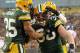 GREEN BAY, WI - JANUARY 15: John Kuhn #30 of the Green Bay Packer celebrates with teammates Ryan Grant #25 and Greg Jennings #85 after scoring a touchdown in the second quarter against the New York Giants during their NFC Divisional playoff game at Lambeau Field on January 15, 2012 in Green Bay, Wisconsin. (Photo by Jamie Squire/Getty Images)