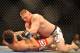 LAS VEGAS - JULY 11: Brock Lesnar holds down Frank Mir during their heavyweight title bout during UFC 100 on July 11, 2009 in Las Vegas, Nevada. Lesnar defeated Mir by a second round knockout. (Photo by Jon Kopaloff/Getty Images)