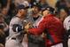 Carlos Pena (left) and Red Sox pitching coach Bob McClure have an exchange over Franklin Morales hitting Luke Scott with a ninth inning pitch. (Care of Getty Images)