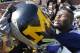 ANN ARBOR, MI - OCTOBER 01: William Campbell #73 of the Michigan Wolverines carries the 'Little Brown Jug' off the field after defeating the Minnesota Golden Gophers 58-0 at Michigan Stadium on October 1, 2011 in Ann Arbor, Michigan. (Photo by Leon Halip/Getty Images)