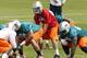 DAVIE, FL - MAY 4: Ryan Tannehill #17 takes a snap from Terrence Brown #60 of the Miami Dolphins during the rookie minicamp on May 4, 2012 at the Miami Dolphins training facility in Davie, Florida. (Photo by Joel Auerbach/Getty Images)
