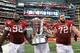 ARLINGTON, TX - OCTOBER 01: (L-R) DeQuinta Jones #92, Travis Swanson #64 and Grant Cook #72 of the Arkansas Razorbacks walk away with the Southwest Classic trophy after beating the Texas A&M Aggies at Cowboys Stadium on October 1, 2011 in Arlington, Texas. (Photo by Ronald Martinez/Getty Images)