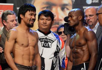 Manny Pacquiao smiling at a very serious Timothy Bradley