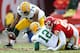 KANSAS CITY, MO - DECEMBER 18: Marshall Newhouse #74 of the Green Bay Packers picks up an Aaron Rodgers #12 fumble caused by Tamba Hali #91 of the Kansas City Chiefs during the game on December 18, 2011 at Arrowhead Stadium in Kansas City, Missouri. (Photo by Jamie Squire/Getty Images)