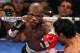 LAS VEGAS, NV - JUNE 09: (L-R) Timothy Bradley lands a left to the head of Manny Pacquiao during their WBO welterweight title fight at MGM Grand Garden Arena on June 9, 2012 in Las Vegas, Nevada. (Photo by Jeff Bottari/Getty Images)