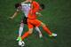 KHARKOV, UKRAINE - JUNE 13: Klaas Jan Huntelaar of Netherlands and Mesut Ozil of Germany battle for the ball during the UEFA EURO 2012 group B match between Netherlands and Germany at Metalist Stadium on June 13, 2012 in Kharkov, Ukraine. (Photo by Christopher Lee/Getty Images)
