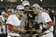 OMAHA, NE - JUNE 28: (L-R) Brady Thomas #36, Michael Roth #29 and Scott Wingo #8 of the South Carolina Gamecocks celebrate with the trophy after winning the men's 2011 NCAA College Baseball World Series at TD Ameritrade Park Omaha on June 28, 2011 in Omaha, Nebraska. The Gamecocks defeated the Florida Gators 5-2 and won the series 2-0. (Photo by Ronald Martinez/Getty Images)