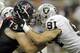 HOUSTON - OCTOBER 09: Tackle Eric Winston #73 of the Houston Texans and dfefensive end Trevor Scott #91 of the Oakland Raiders lockup on the line of scrimmage at Reliant Stadium on October 9, 2011 in Houston, Texas. (Photo by Bob Levey/Getty Images)