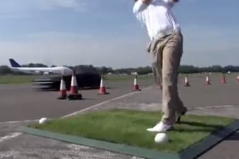 Watch a F1 Driver Catch a Golf Ball in His Car Going 180 Miles Per Hour
