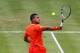 LONDON, ENGLAND - JUNE 14: Jo-Wilfried Tsonga of France hits a backhand return during his mens singles third round match against Ivan Dodig of Croatia on day four of the AEGON Championships at Queens Club on June 14, 2012 in London, England. (Photo by Clive Brunskill/Getty Images)