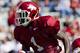 FAYETTEVILLE, AR - APRIL 21: Marquel Wade #1 of the Arkansas Razorbacks Red Team is tackled by Houston Pruitt #30 of the White Team during the Spring Game at Donald W. Reynolds Stadium on April 21, 2012 in Fayetteville, Arkansas. (Photo by Wesley Hitt/Getty Images)