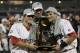 OMAHA, NE - JUNE 28: (L-R) Brady Thomas #36, Michael Roth #29 and Scott Wingo #8 of the South Carolina Gamecocks celebrate with the trophy after winning the men's 2011 NCAA College Baseball World Series at TD Ameritrade Park Omaha on June 28, 2011 in Omaha, Nebraska. The Gamecocks defeated the Florida Gators 5-2 and won the series 2-0. (Photo by Ronald Martinez/Getty Images)