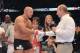 Russia's President Vladimir Putin (front R) congratulates heavyweight mixed martial artist Fedor Emelianenko (front L) after watching his fight against Pedro Rizzo entitled 'M-1 Global: Fedor vs. Rizzo,' at Ice Palace in Saint-Petersburg, late on June 21, 2012. AFP PHOTO / RIA-NOVOSTI / POOL/ ALEXEI NIKOLSKY
