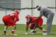 KANSAS CITY, MO - MAY 13: Ethan Johnson #70 and Dontari Poe #92 of the Kansas City Chiefs work with defensive coach Anthony Pleasant during the Kansas City Chiefs minicamp on May 13, 2012 at the Chiefs Training Facility in Kansas City, Missouri. (Photo by Kyle Rivas/Getty Images)