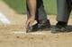 PITTSBURGH - MAY 9: An umpire cleans the plate during the game between the Pittsburgh Pirates and the Los Angeles Dodgers on May 9, 2004 at PNC Park in Pittsburgh, Pennsylvania . The Dodgers won 9-7. (Photo by Rick Stewart/Getty Images)