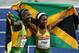 BERLIN - AUGUST 17: Kerron Stewart (L) of Jamaica and Shelly-Ann Fraser of Jamaica celebrate silver and gold respectively after the women's 100 Metres Final during day three of the 12th IAAF World Athletics Championships at the Olympic Stadium on August 17, 2009 in Berlin, Germany. (Photo by Mark Dadswell/Getty Images)