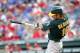 ARLINGTON, TX - JUNE 28: Josh Reddick #16 of the Oakland Athletics hits a home run in the first inning against the Texas Rangers at Rangers Ballpark in Arlington on June 28, 2012 in Arlington, Texas. (Photo by Rick Yeatts/Getty Images)