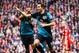 LIVERPOOL, ENGLAND - MARCH 03: Robin van Persie of Arsenal celebrates scoring the equalising goal with teammate Theo Walcott (L) during the Barclays Premier League match between Liverpool and Arsenal at Anfield on March 3, 2012 in Liverpool, England. (Photo by Clive Mason/Getty Images)