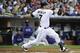 SAN DIEGO, CA - JUNE 18: Chase Headley #7 of the San Diego Padres hits an RBI double during the first inning of an interleague baseball game against the Texas Rangers at Petco Park on June 18, 2012 in San Diego, California. (Photo by Denis Poroy/Getty Images)