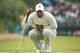 LYTHAM ST ANNES, ENGLAND - JULY 19: Tiger Woods of the United States lines up a putt on the twelveth green during the first round of the 141st Open Championship at Royal Lytham & St Annes Golf Club on July 19, 2012 in Lytham St Annes, England. (Photo by Andrew Redington/Getty Images)