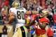 SAN FRANCISCO, CA - JANUARY 14: Jimmy Graham #80 of New Orleans Saints pushes away from Carlos Rogers #22 of the San Francisco 49ers and goes 66 yards for a touchdown in the fourth quarter during the NFC Divisional playoff game at Candlestick Park on January 14, 2012 in San Francisco, California. (Photo by Thearon W. Henderson/Getty Images)