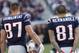 Jan 1, 2012; Foxborough, MA, USA; New England Patriots tight end Rob Gronkowski (87) and tight end Aaron Hernandez (81) watch from the sideline as they take on the Buffalo Bills in the second quarter at Gillette Stadium. The Patriots defeated the Bill 49-21. Mandatory Credit: David Butler II-US PRESSWIRE