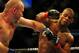 Jul 21, 2012; Calgary, AB, CANADA; Tim Boetsch (blue gloves) and Hector Lombard (red gloves) during the middleweight bout of UFC 149 at the Scotiabank Saddledome. Mandatory Credit: Anne-Marie Sorvin-US PRESSWIRE