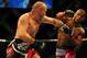 Jul 21, 2012; Calgary, AB, CANADA; Tim Boetsch (blue gloves) and Hector Lombard (red gloves) during the middleweight bout of UFC 149 at the Scotiabank Saddledome. Mandatory Credit: Anne-Marie Sorvin-US PRESSWIRE