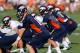 ENGLEWOOD, CO - JULY 26: Quarterback Peyton Manning #18 of the Denver Broncos leads the quarterbacks in drills during training camp at the Paul D. Bowlen Memorial Broncos Centre at Dove Valley on July 26, 2012 in Englewood, Colorado. (Photo by Doug Pensinger/Getty Images)