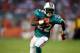 MIAMI GARDENS, FL - SEPTEMBER 12: Running back Reggie Bush #22 of the Miami Dolphins runs against the New England Patriots at Sun Life Stadium on September 12, 2011 in Miami Gardens, Florida. (Photo by Marc Serota/Getty Images)