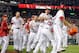 WASHINGTON, DC - JULY 17: Ryan Zimmerman #11 of the Washington Nationals celebrates with teammates after scoring the game winning run in the tenth inning against the New York Mets at Nationals Park on July 17, 2012 in Washington, DC. Washington won the game 5-4. (Photo by Greg Fiume/Getty Images)