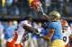 Dec 31, 2011; San Francisco CA, USA; UCLA Bruins tight end Joseph Fauria (8) removes the helmet from Illinois Fighting Illini defensive lineman Whitney Mercilus (85) during the second quarter of the Fight Hunger Bowl at AT&T Park. Mandatory Credit: Jason O. Watson-US PRESSWIRE