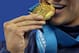 SHANGHAI, CHINA - JULY 26: A detail of Ryan Lochte of the United States as he bites his gold medal with a grill in his moutch after the Men's 200m Freestyle Final during Day Eleven of the 14th FINA World Championships at the Oriental Sports Center on July 26, 2011 in Shanghai, China. (Photo by Clive Rose/Getty Images)