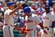 PHILADELPHIA, PA - JULY 25: Shane Victorino #8 of the Philadelphia Phillies is congratulated by Hunter Pence #3 after scoring on a double by Chase Utley #26 (not pictured) against of the Milwaukee Brewers during a MLB baseball game on July 25, 2012 at Citizens Bank Park in Philadelphia, Pennsylvania. (Photo by Rich Schultz/Getty Images)
