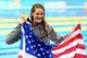 LONDON, ENGLAND - JULY 30: Missy Franklin of the United States celebrates with her gold medal and an American flag during the medal ceremony for the Women's 100m Backstroke on Day 3 of the London 2012 Olympic Games at the Aquatics Centre on July 30, 2012 in London, England. (Photo by Al Bello/Getty Images)