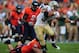 Sep 3, 2011; Charlottesville, VA, USA; William & Mary Tribe running back Jonathan Grimes (34) stiff arms a Virginia Cavaliers defender during the first quarter at Scott Stadium. Mandatory Credit: Andrew Weber-US PRESSWIRE