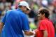 LONDON, ENGLAND - AUGUST 02: Roger Federer (R) of Switzerland shakes hands with John Isner (L) of the United States after defeating him in the Quarterfinal of Men's Singles Tennis on Day 6 of the London 2012 Olympic Games at Wimbledon on August 2, 2012 in London, England. (Photo by Clive Brunskill/Getty Images)