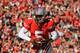 COLUMBUS, OH - NOVEMBER 5: Quarterback Braxton Miller #5 of the Ohio State Buckeyes scores the second of his two touchdowns against Indiana in the second half as Ryan Phillis #25 of the Indiana Hoosiers and Alexander Webb #27 of the Indiana Hoosiers give chase at Ohio Stadium on November 5, 2011 in Columbus, Ohio. Ohio State defeated Indiana 34-20. (Photo by Jamie Sabau/Getty Images)