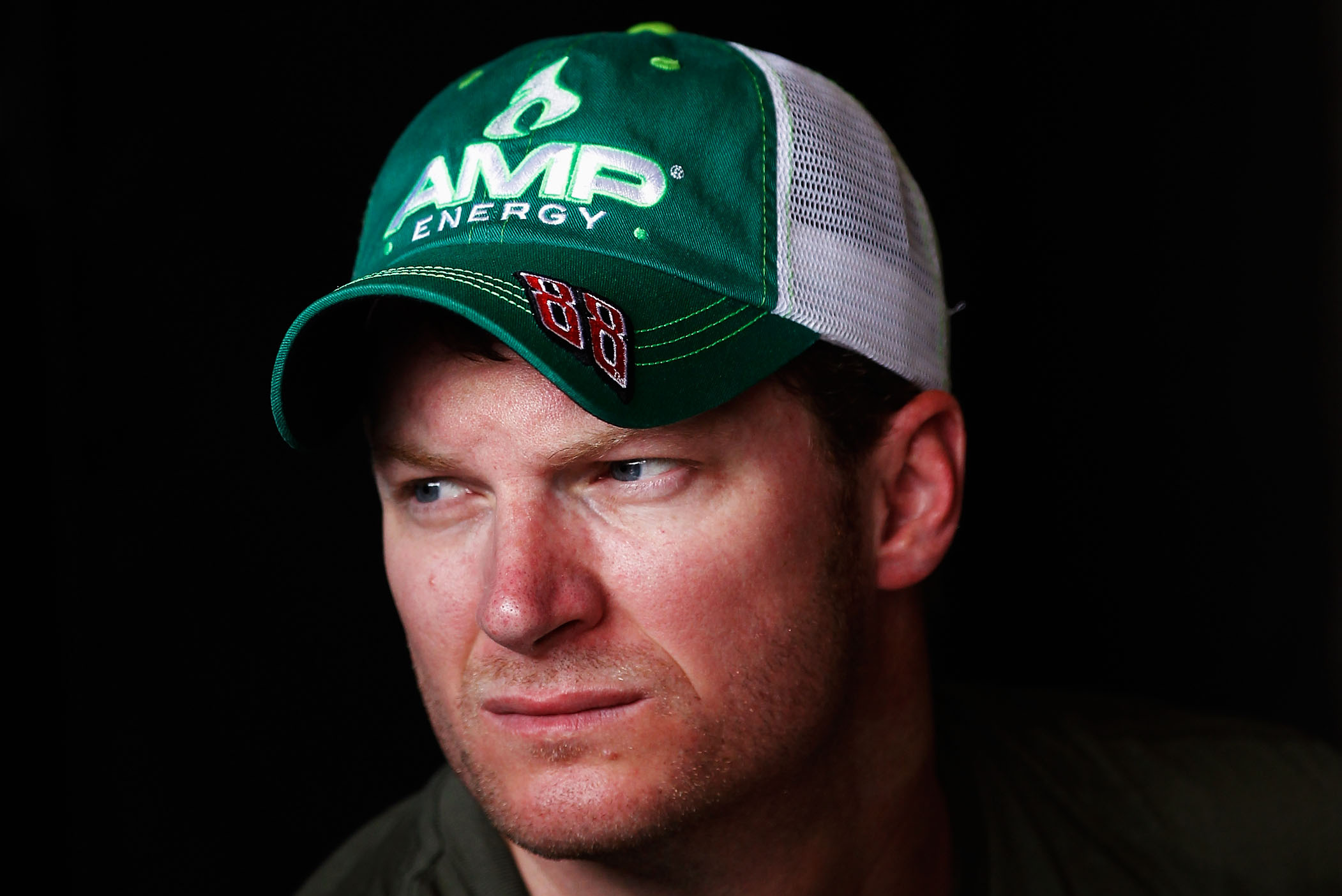 INDIANAPOLIS, IN - JULY 28: Dale Earnhardt Jr., driver of the #88 AMP Energy/National Guard Chevrolet, looks on in the garage area during practice for the NASCAR Sprint Cup Series Crown Royal presents the Curtiss Shaver 400 at the Brickyard at Indianapolis Motor Speedway on July 28, 2012 in Indianapolis, Indiana. (Photo by Tom Pennington/Getty Images for NASCAR)