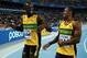 DAEGU, SOUTH KOREA - SEPTEMBER 04: (R-L) Yohan Blake and Usain Bolt of Jamaica celebrate victory and a new world record in the men's 4x100 metres relay final during day nine of 13th IAAF World Athletics Championships at Daegu Stadium on September 4, 2011 in Daegu, South Korea. (Photo by Stu Forster/Getty Images)