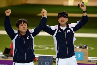 Young Rae Choi of South Korea, left, and countryman Jongoh Jin salute the crowd after an exciting final round.