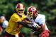 ASHBURN, VA - JULY 26: Robert Griffin III #10 hands the ball off to Evan Royster #35 of the Washington Redskins during training camp at Redskins Park on July 26, 2012 in Ashburn, Virginia. (Photo by Patrick McDermott/Getty Images)