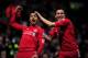 NORWICH, ENGLAND - APRIL 28: (L-R) Luis Suarez of Liverpool is congratulated by teammate Stewart Downing after scoring his team's thord goal during the Barclays Premier League match between Norwich City and Liverpool at Carrow Road on April 28, 2012 in Norwich, England. (Photo by Jamie McDonald/Getty Images)