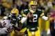 GREEN BAY, WI - DECEMBER 25: Quarterback Aaron Rodgers #12 of the Green Bay Packers is chased out of the pocket while playing the Chicago Bears at Lambeau Field on December 25, 2011 in Green Bay, Wisconsin. (Photo by Matthew Stockman/Getty Images)