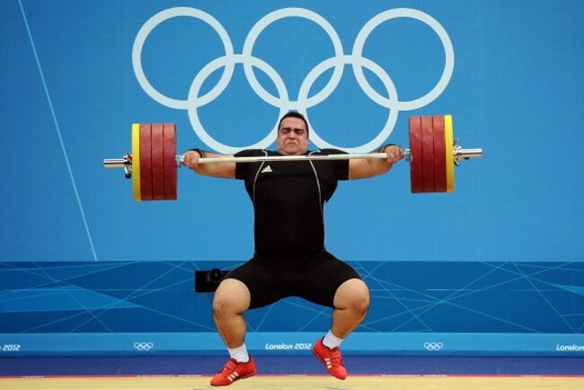 Iran's Behdad Salimi goes through his lift in the last day of Olympic weightlifting.