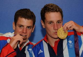 Great Britain's Jonathan Brownlee, left, and older brother Alistair celebrate after medaling at the Men's Triathlon.